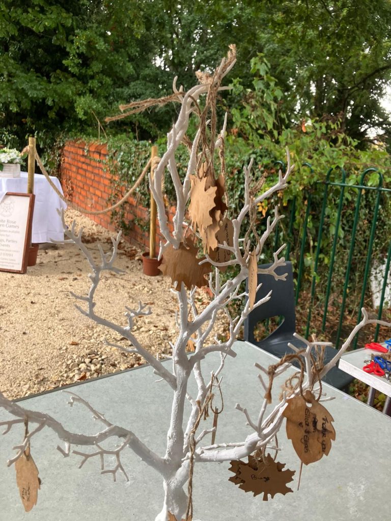 A faux tree with cut outs of brown leaves attached with string